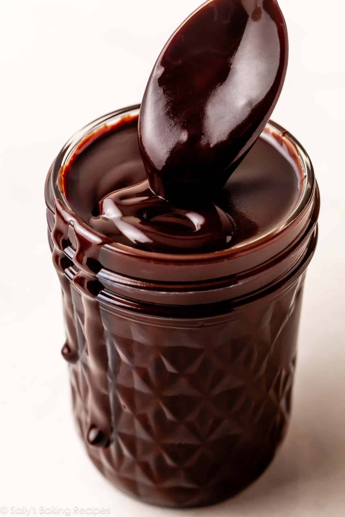 close-up of hot fudge sauce in glass jar.