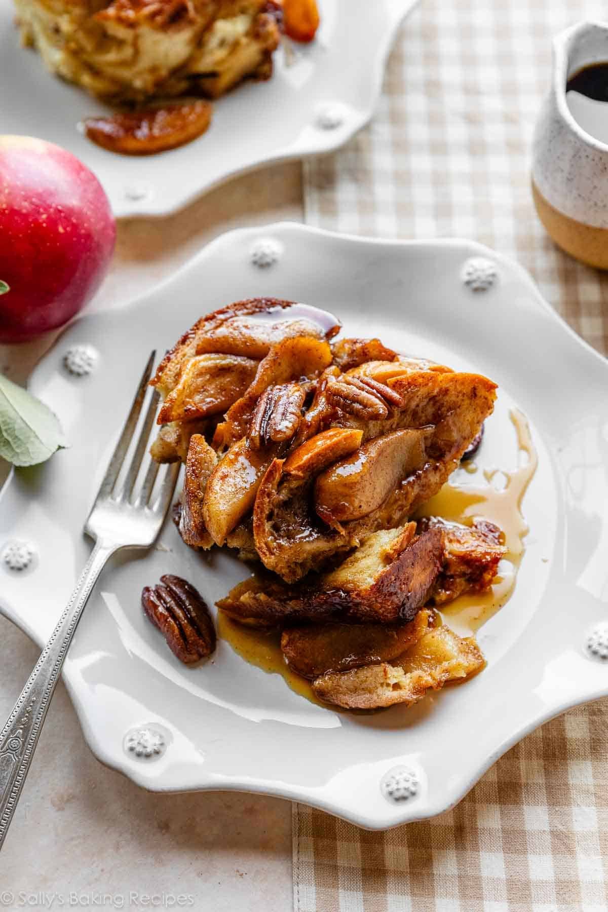 baked apple french toast casserole serving on white plate.