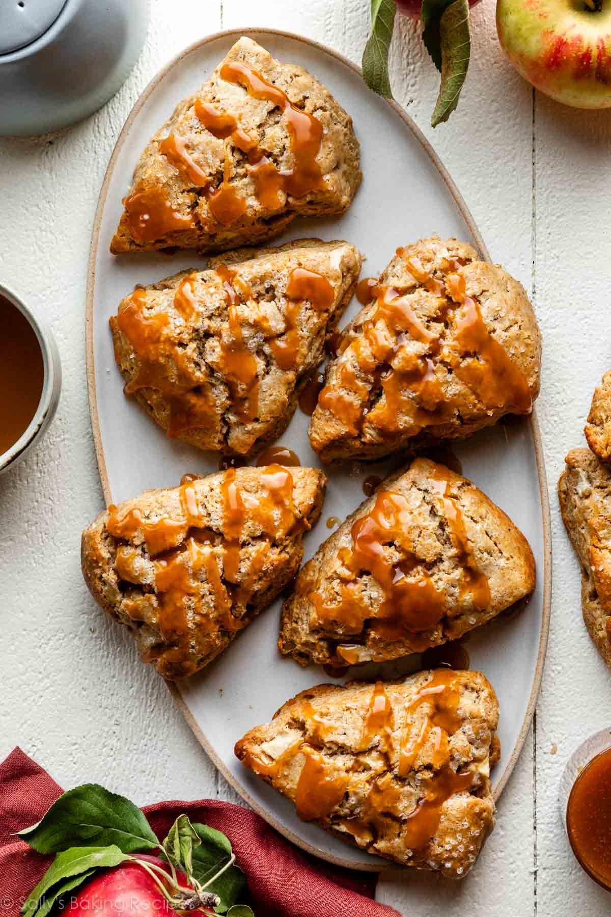 apple scones with caramel sauce drizzled on top.