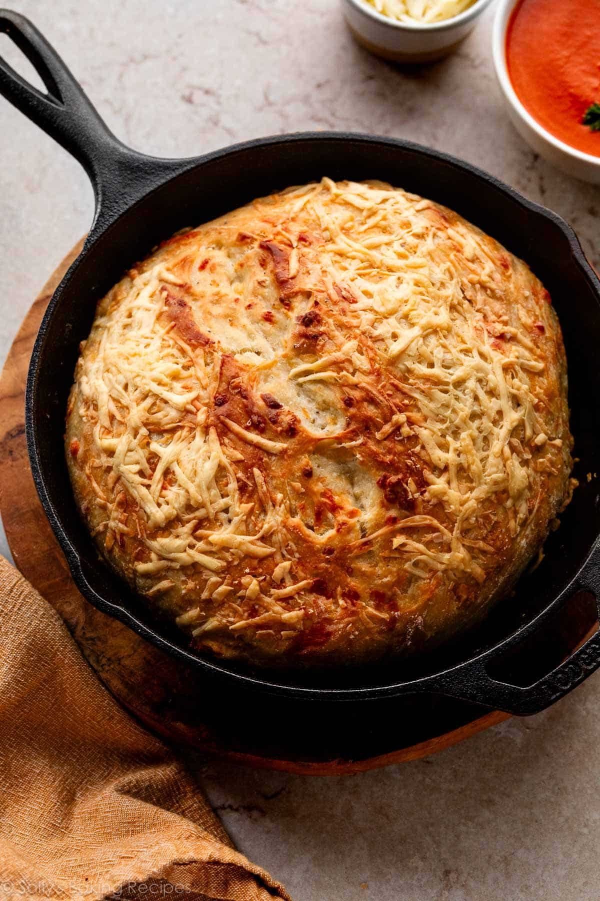 asiago-crusted bread in cast iron skillet.