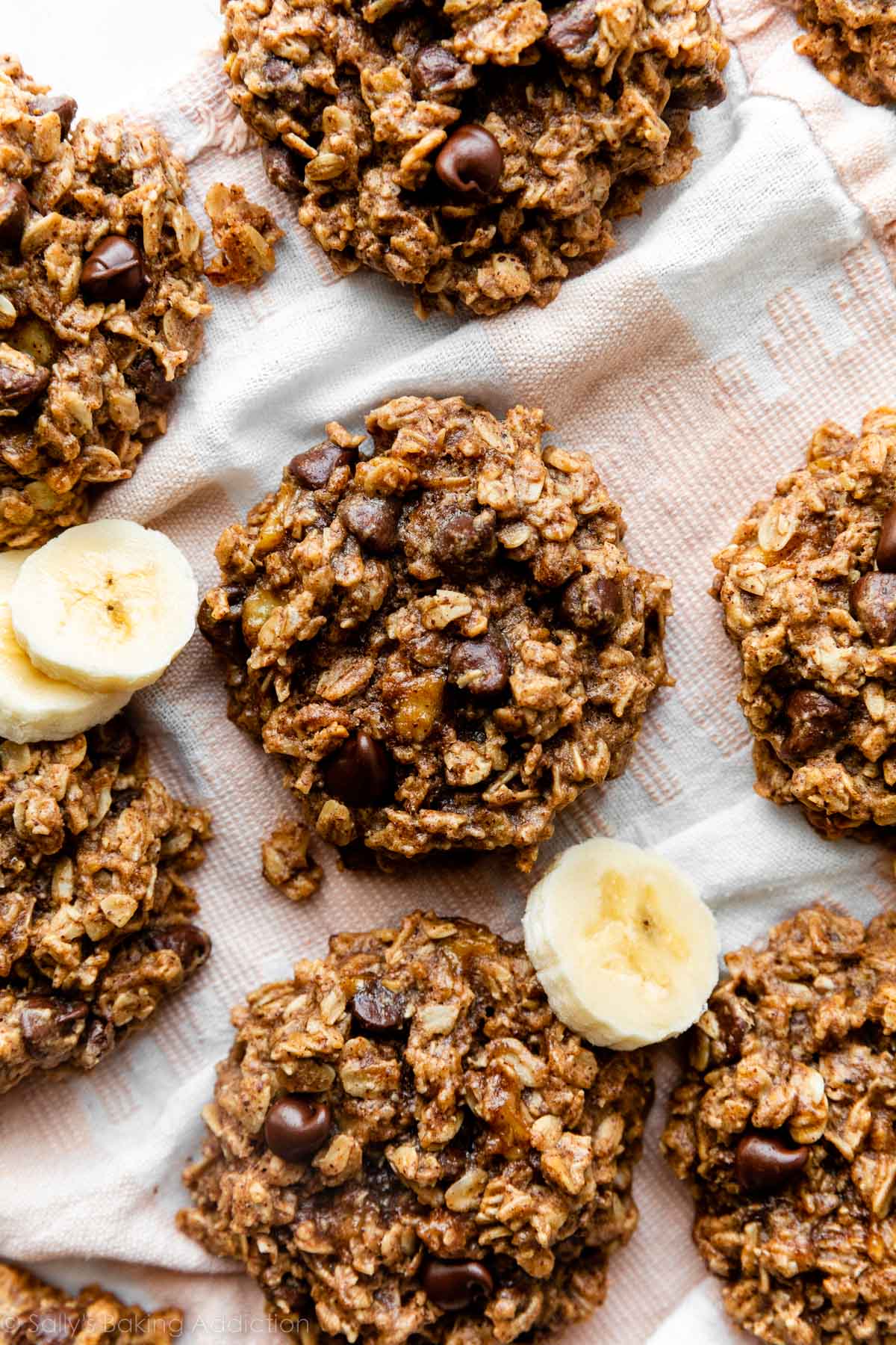 banana oatmeal breakfast cookies with chocolate chips on pink and white linen.