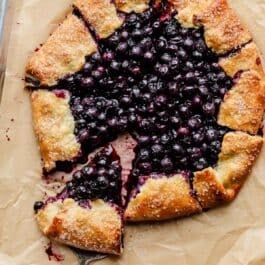 blueberry galette with slice being removed.