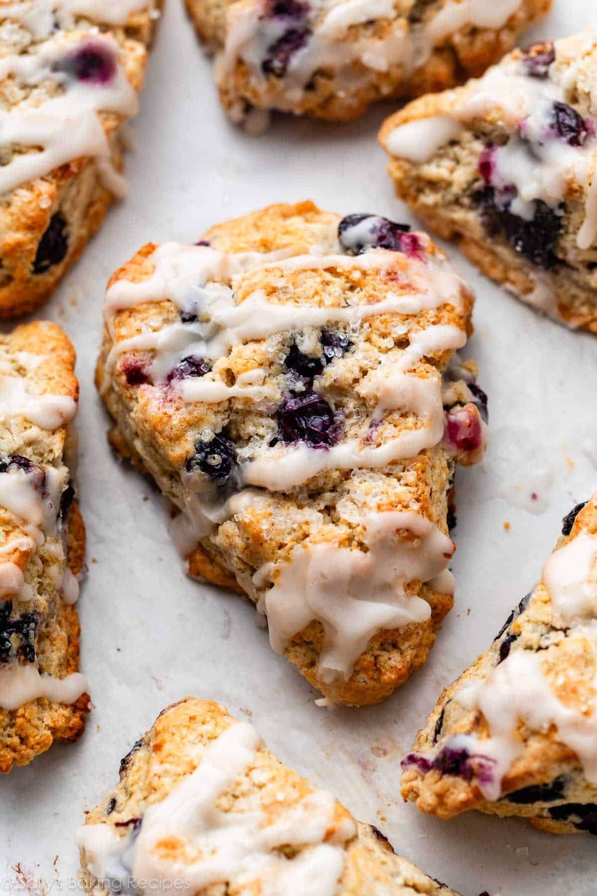 blueberry scones with icing on top.