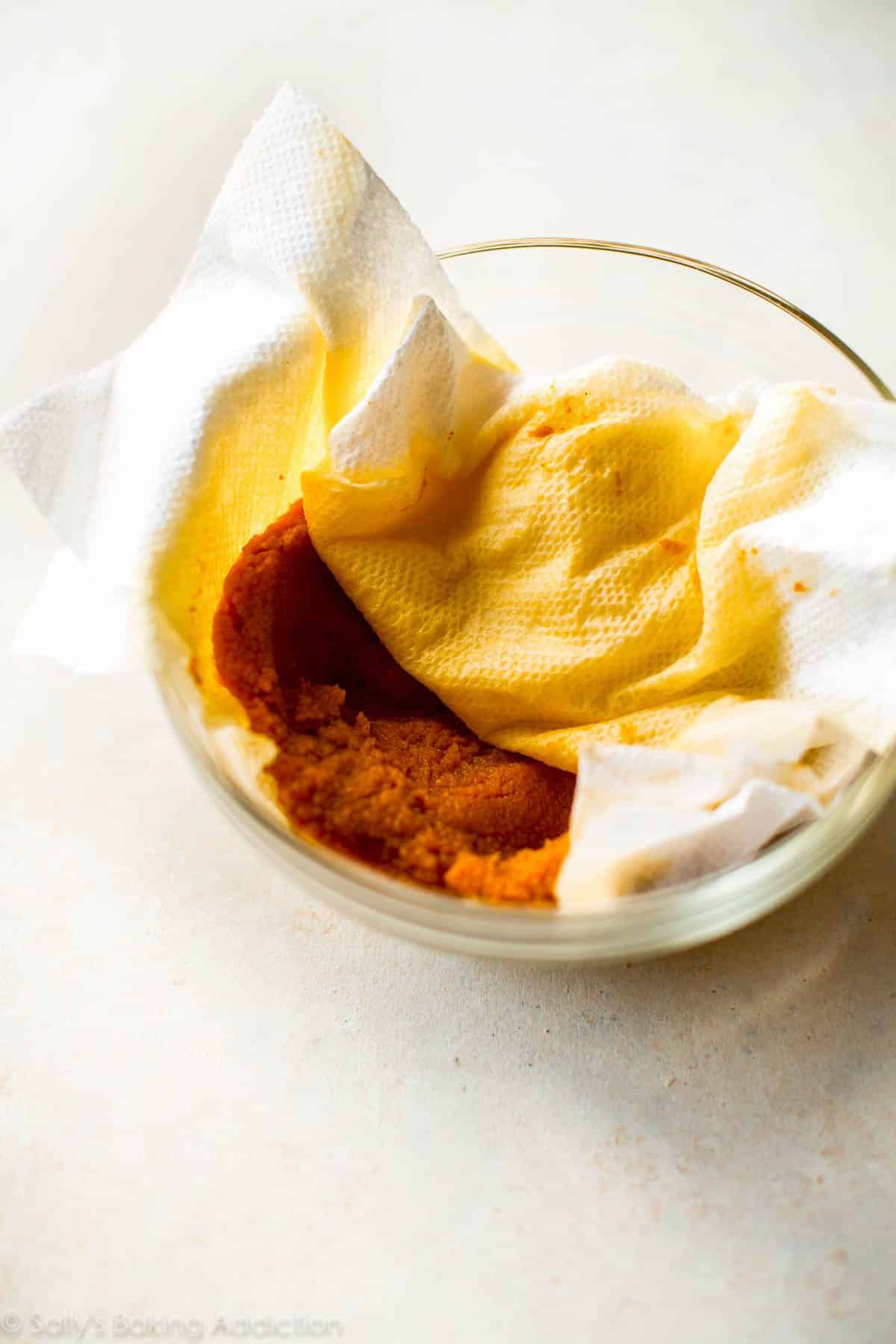 blotted pumpkin with a paper towel in a glass bowl