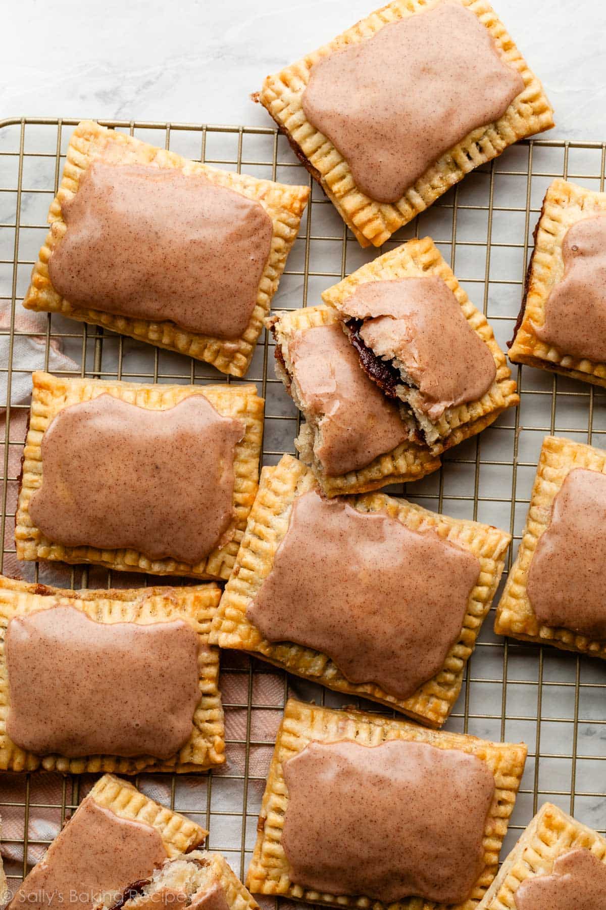 overhead photo of homemade brown sugar cinnamon pop tarts on gold cooling rack.