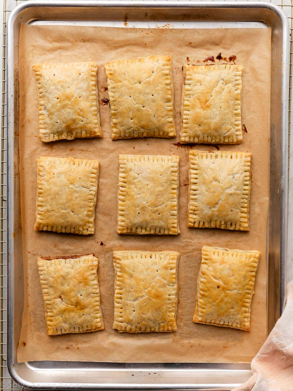 baked homemade pop tarts on parchment lined baking sheet.