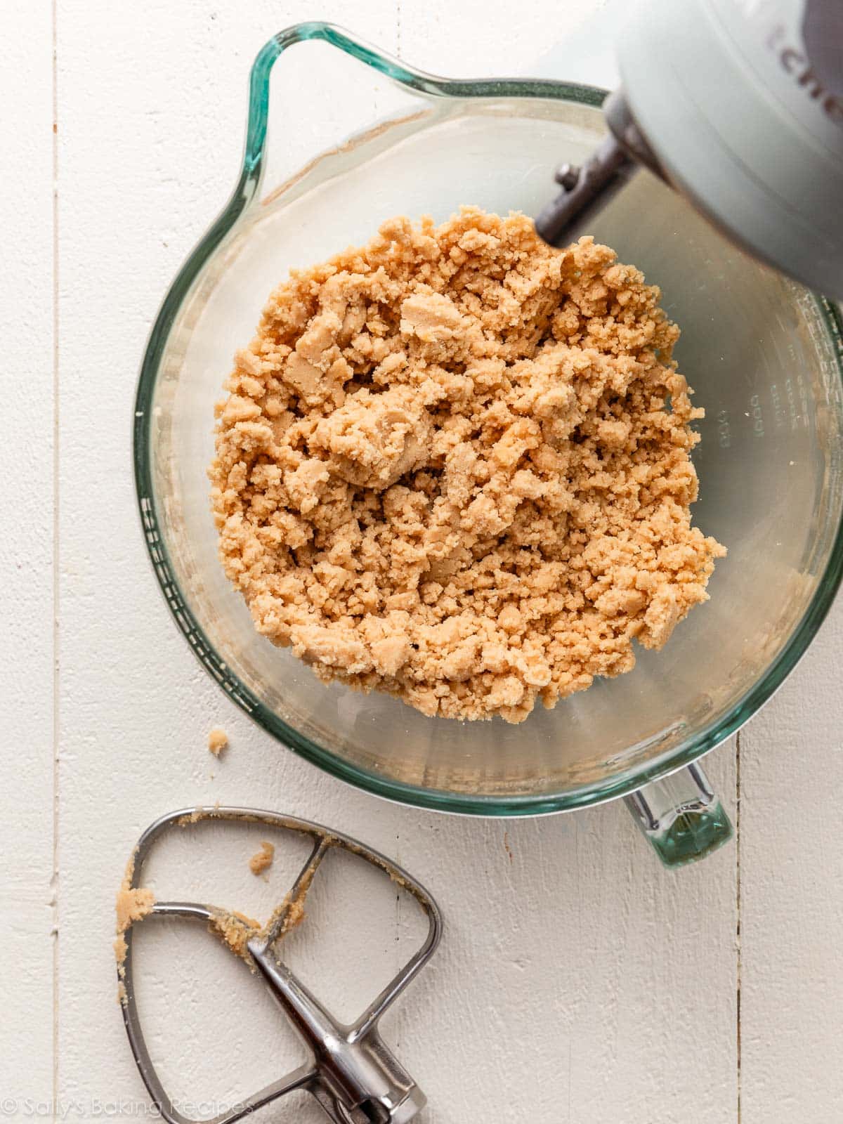 crumbly cookie dough in mixer bowl.