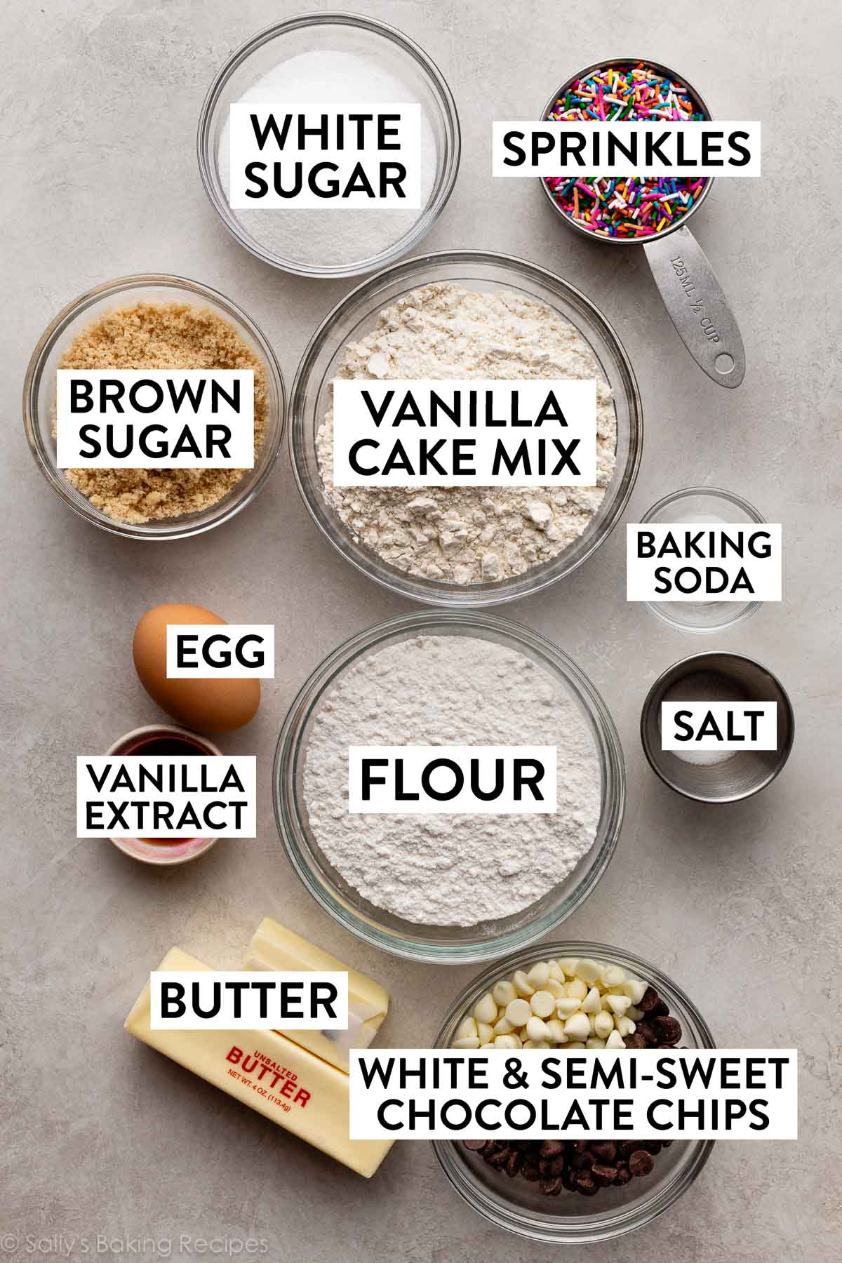 ingredients on counter including flour, vanilla cake mix, butter, vanilla, brown sugar, egg, and sprinkles.