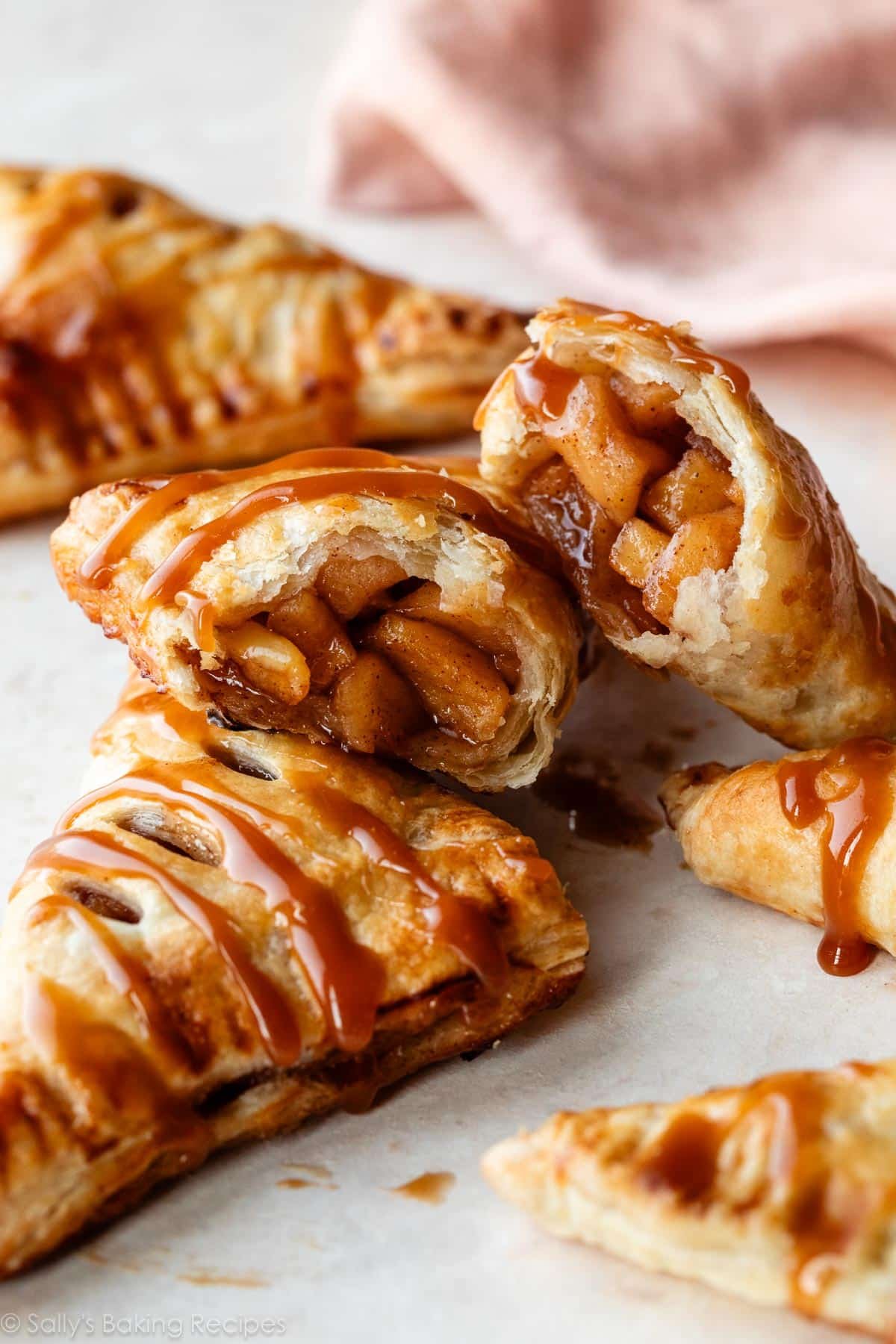 caramel apple turnover cut in half to show cinnamon apple filling.