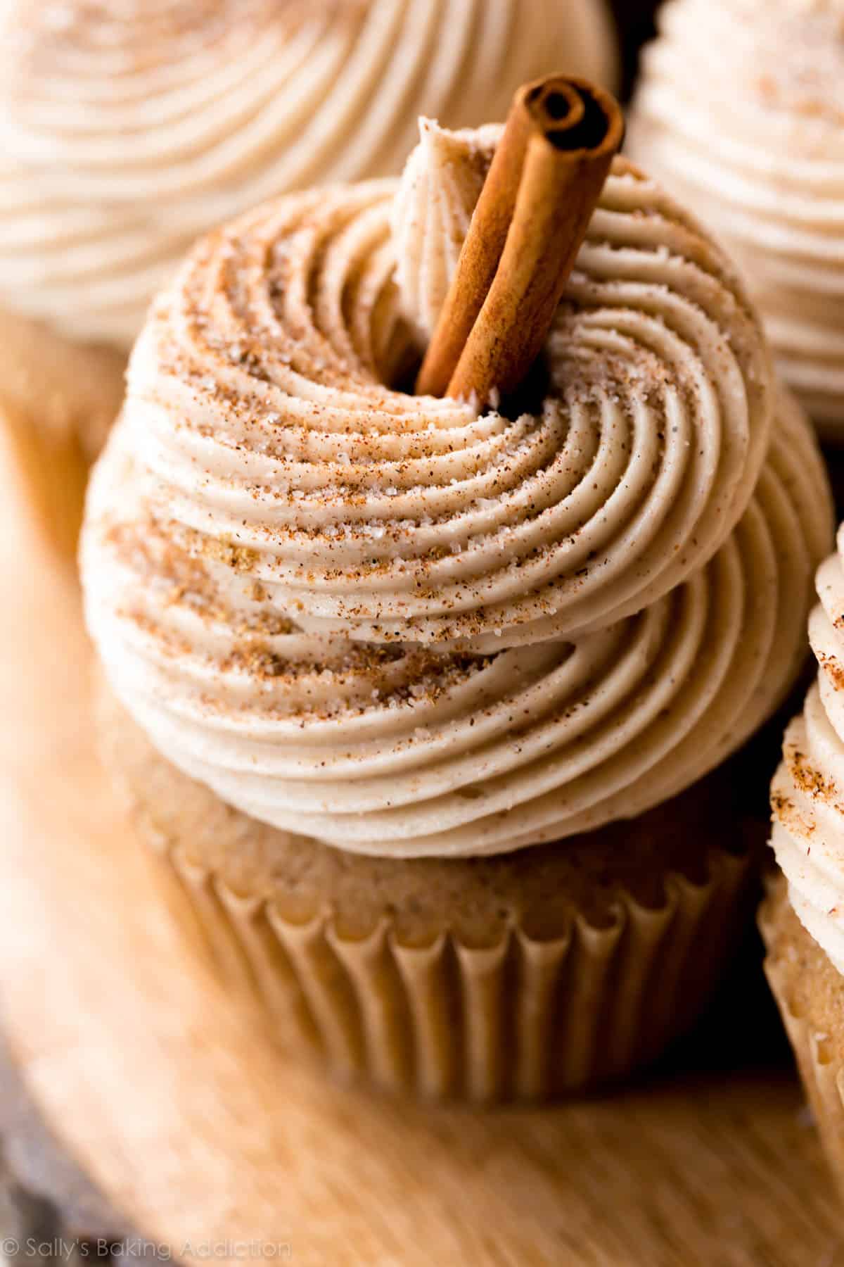 chai latte cupcake with chai buttercream and a cinnamon stick garnish