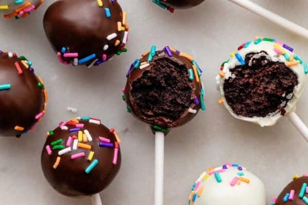 chocolate cake pops dipped in chocolate and white chocolate with rainbow sprinkles.