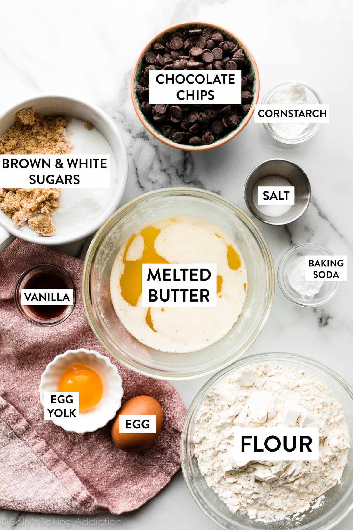 ingredients in bowls including melted butter, chocolate chips, cornstarch, flour, vanilla, and sugars