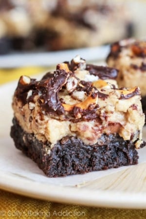 chocolate pretzel peanut butter brownies on a cream plate