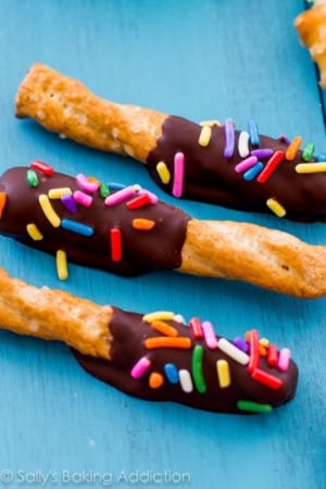 pretzels dipped in chocolate and topped with sprinkles