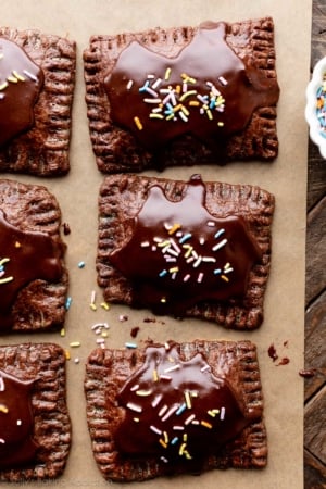 chocolate pastry pop tarts with icing and rainbow sprinkles