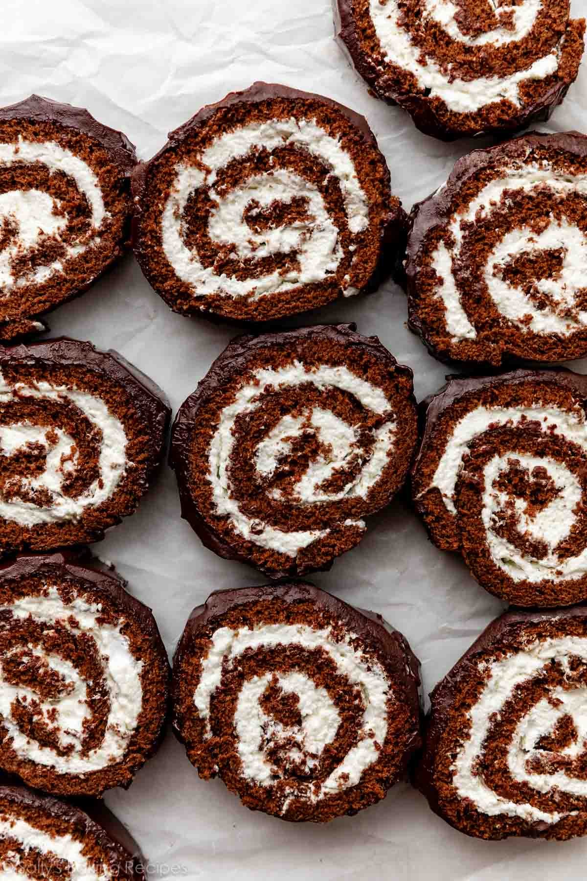 overhead photo of chocolate cake roll slices with ganache on top.