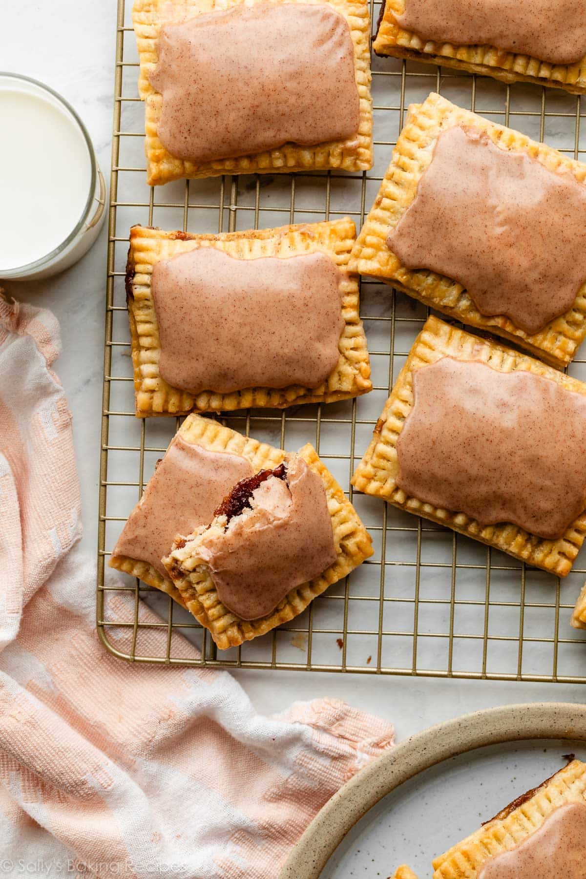 homemade frosted pop tarts on cooling rack with pink linen.