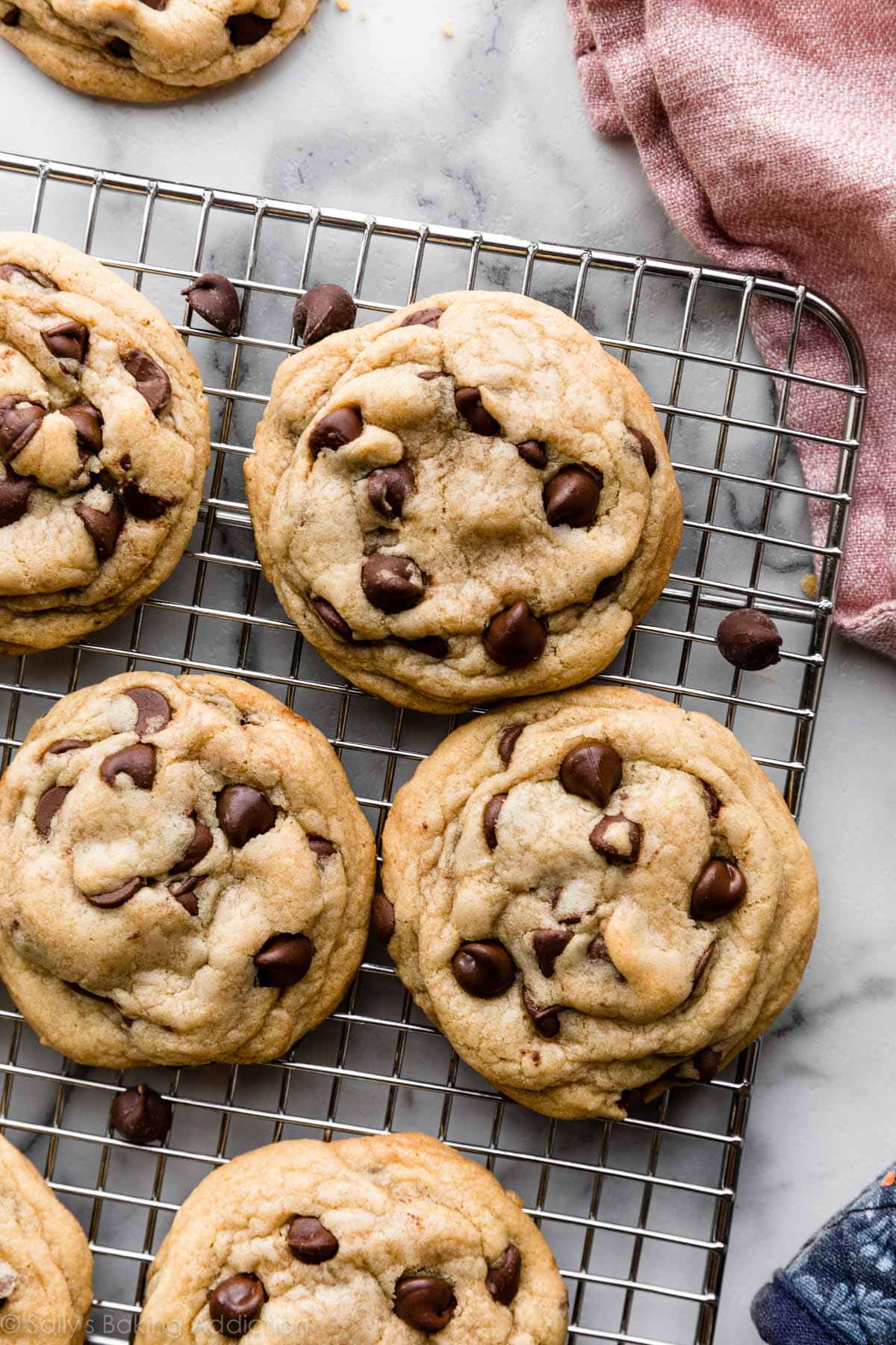 6 chocolate chip cookies on silver wire cooling rack