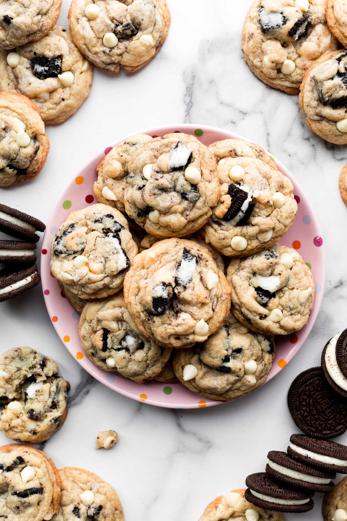 Oreo cookies and cream cookies on pink plate