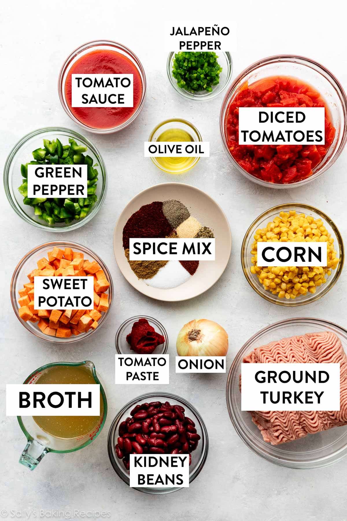 bowls in ingredients including ground meat, diced tomatoes, corn, sweet potato, spice mix, kidney beans, onion, and green pepper.