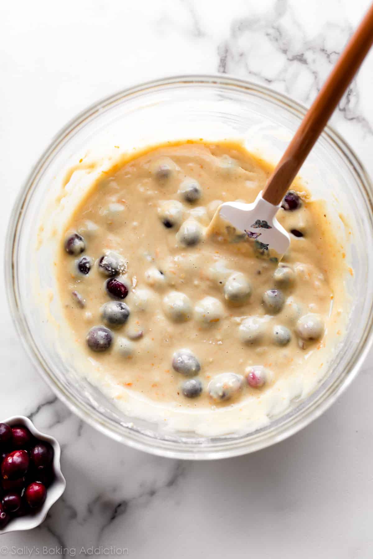 cranberry orange bread batter in a glass bowl