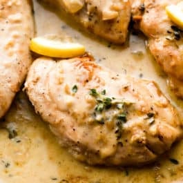 chicken breasts in creamy lemon thyme sauce in cast iron skillet