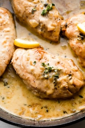 chicken breasts in creamy lemon thyme sauce in cast iron skillet