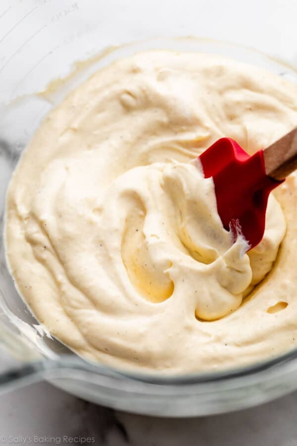 vanilla bean pastry cream with whipped cream folded in with red spatula.