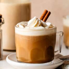 pumpkin coffee with whipped cream and cinnamon stick.