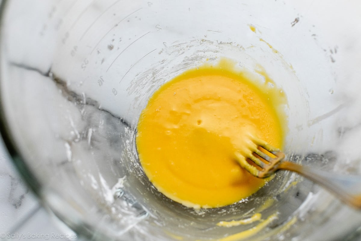 fork in yellow mixture in glass bowl.