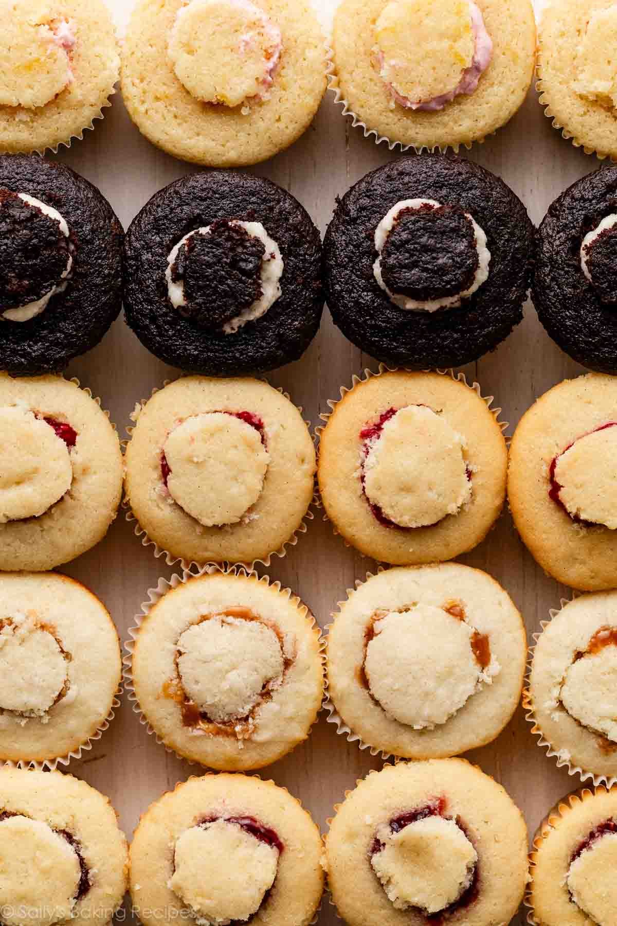 variety of cupcakes with filling including vanilla, lemon, and chocolate.