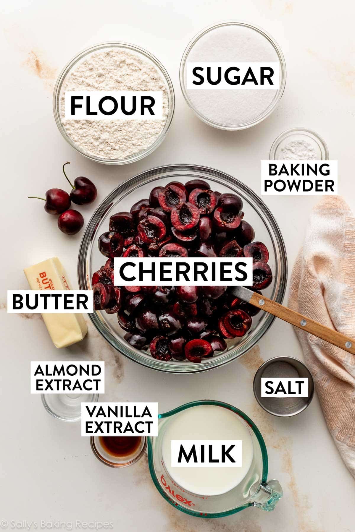 flour, sugar, baking powder, milk, salt, vanilla, butter measured out in bowls.