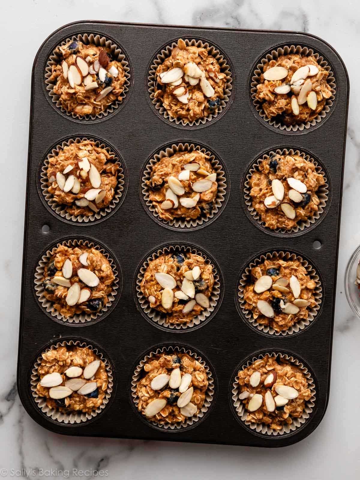 almond oat batter in lined muffin pan.