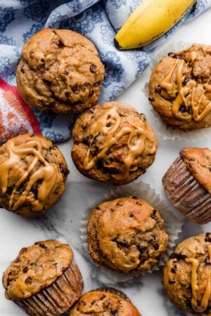 healthier peanut butter banana muffins with mini chocolate chips and blue linen napkin.