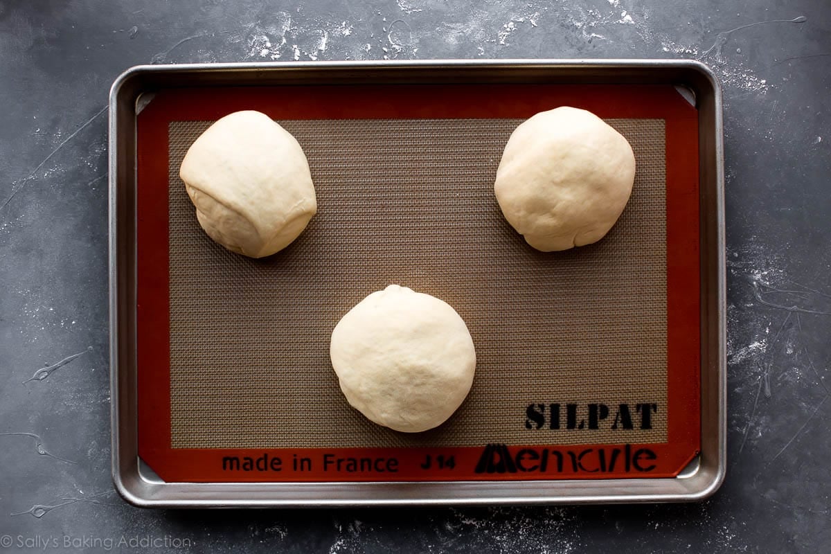 bread bowls dough on baking sheet before baking