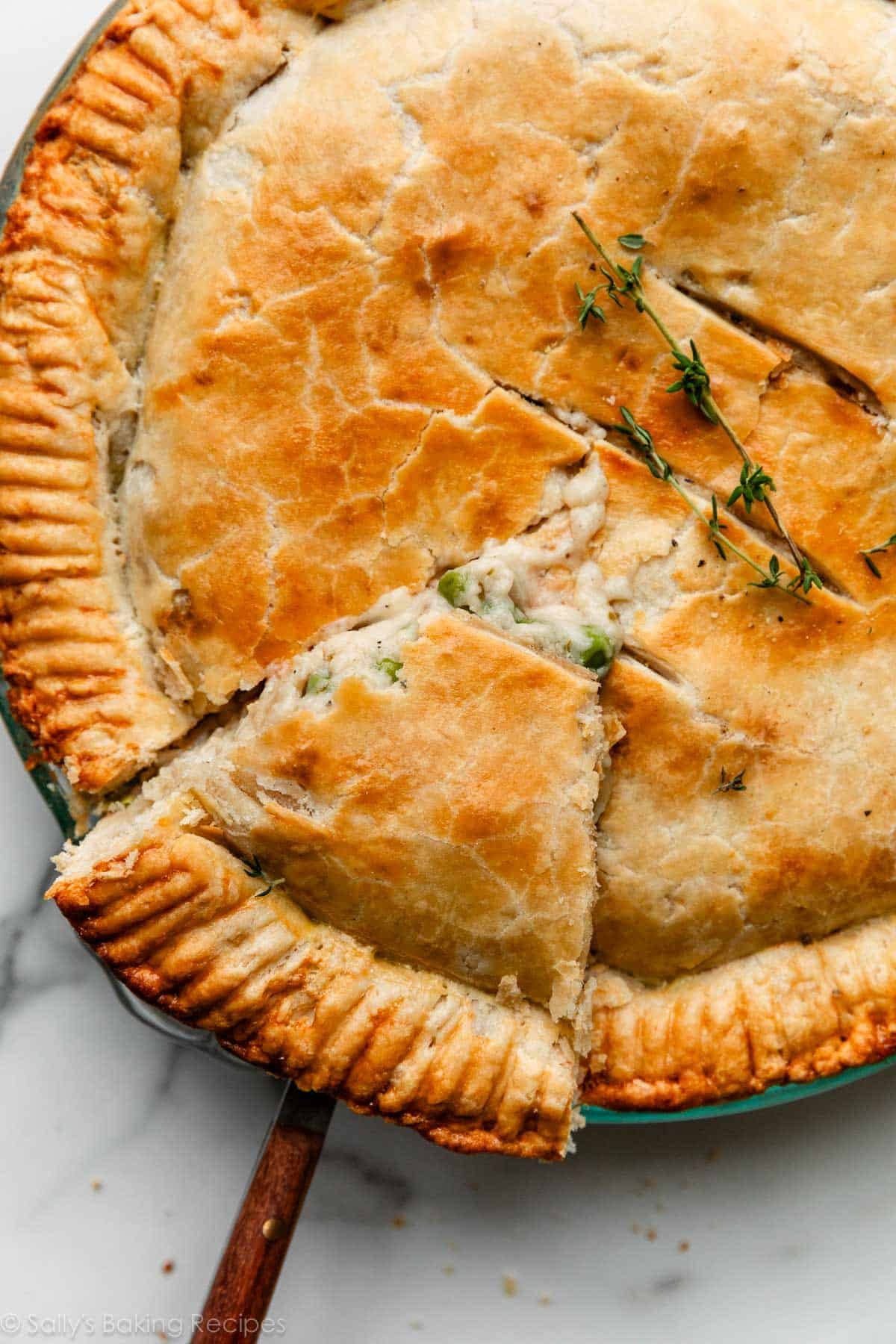 overhead close-up photo of double crust pot pie with 1st slice cut.