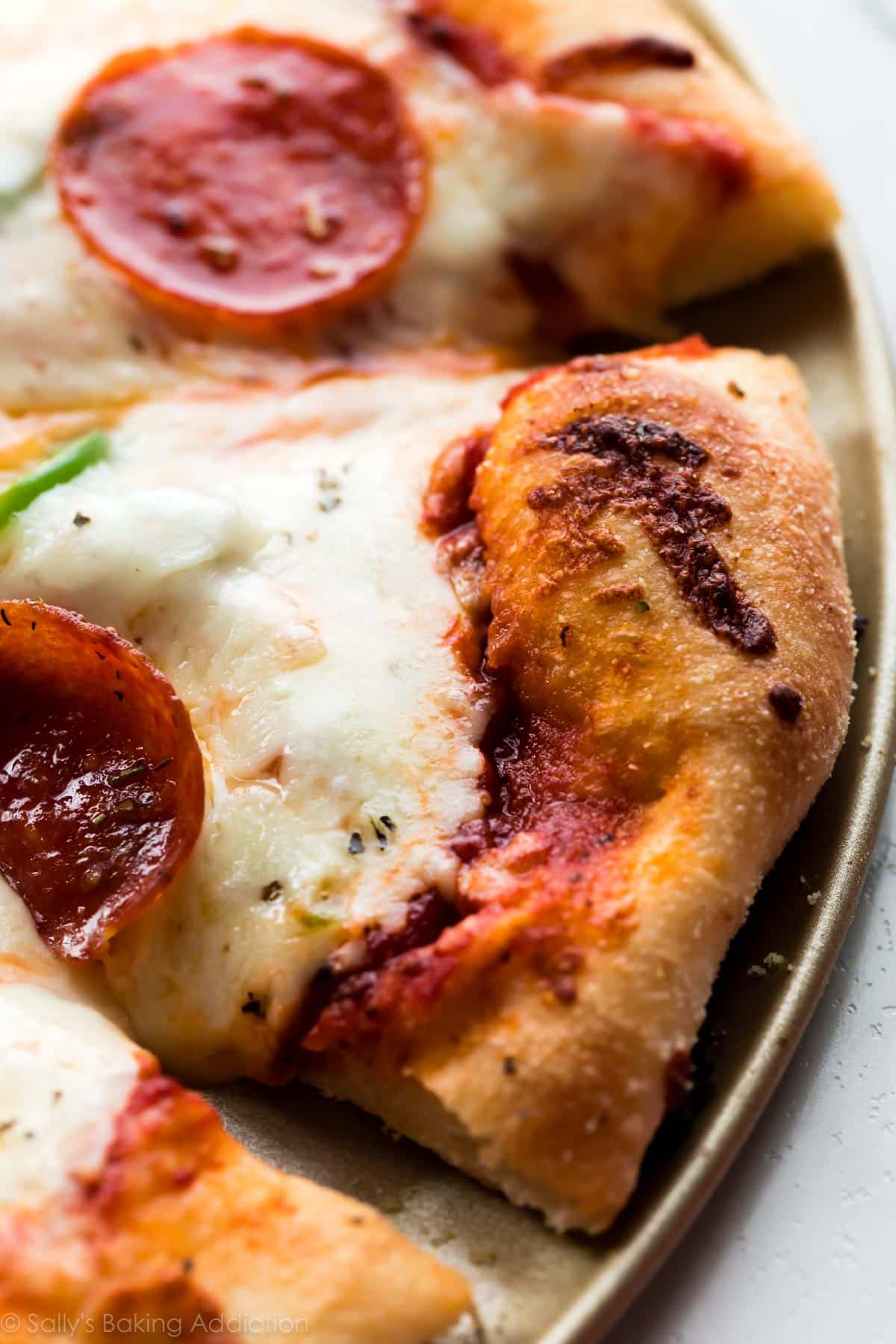 Homemade pizza on baking sheet