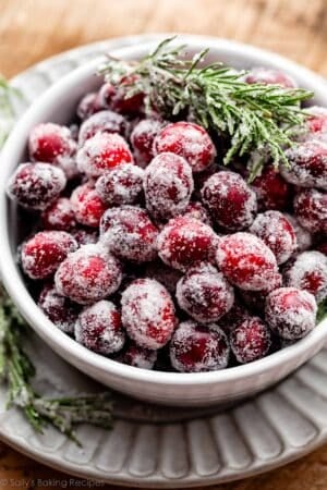 sugared cranberries and rosemary in bowl.