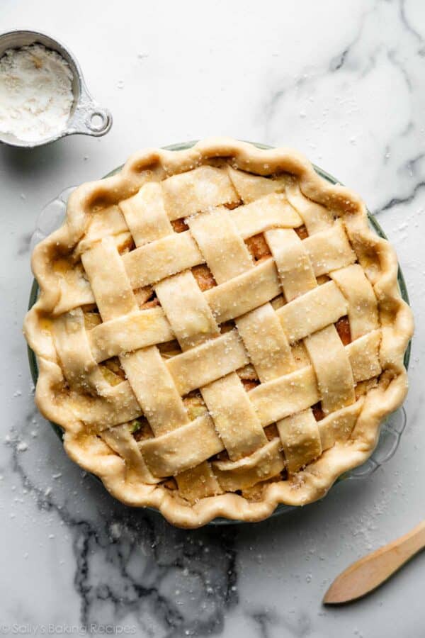 unbaked apple pie with lattice pie crust top and fluted edges.