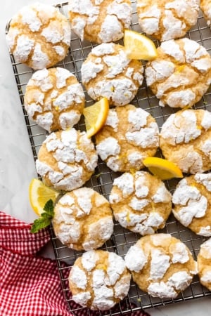 lemon crinkle cookies arranged on wire cooling rack.