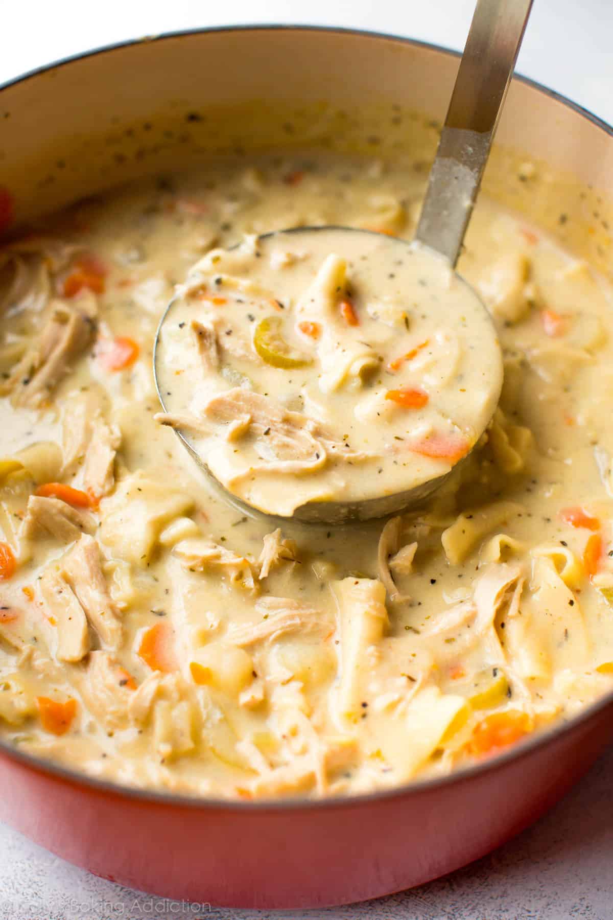 Homemade creamy chicken noodle soup in a pot.