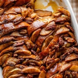 close-up overhead photo of apple french toast casserole with pecans on top.