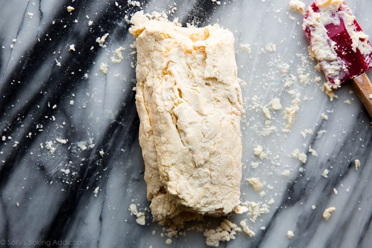 biscuit dough rectangle with left and right sides folded over forming a skinny rectangle