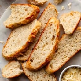 slices of asiago bread on marble platter.