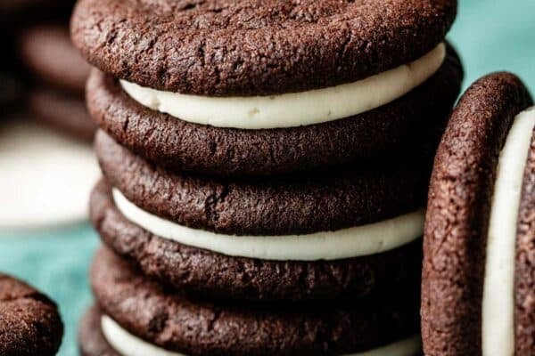 stack of 3 homemade Oreos on blue linen.