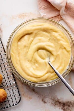 pastry cream in glass bowl with spoon.