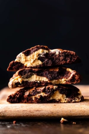 stack of peanut butter filled brownie cookies broken in half