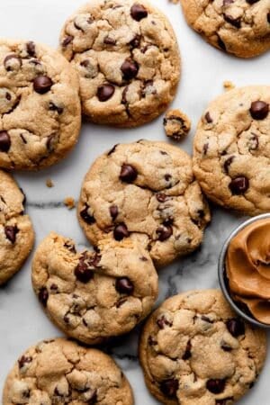 peanut butter chocolate chip cookies on marble backdrop.