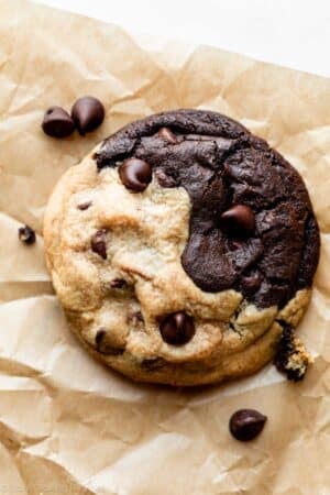 close-up photo of a chocolate and peanut butter swirl cookie on brown parchment paper.