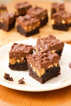 peanut butter cup crunch brownies on a cream plate